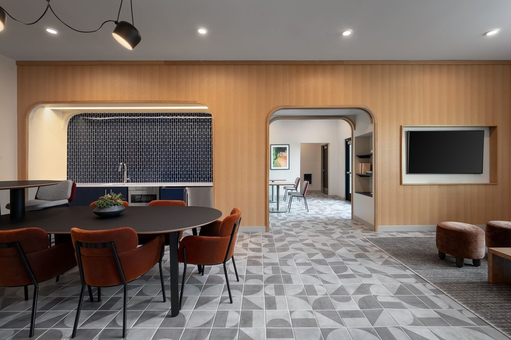 A modern dining room with a round table and chairs.