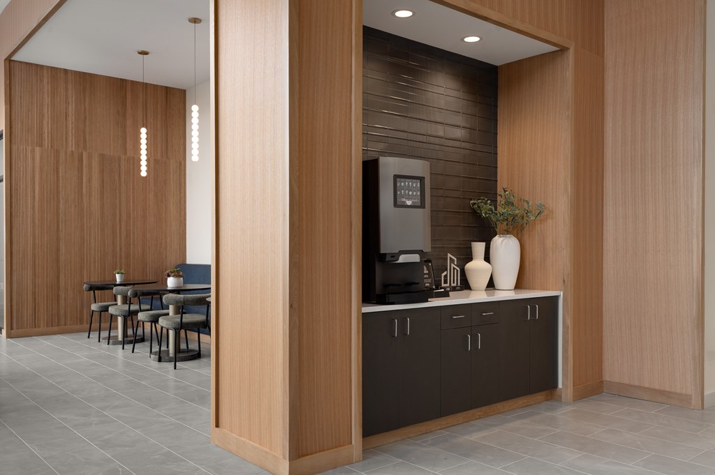 A modern kitchen with wooden cabinets and a black countertop.