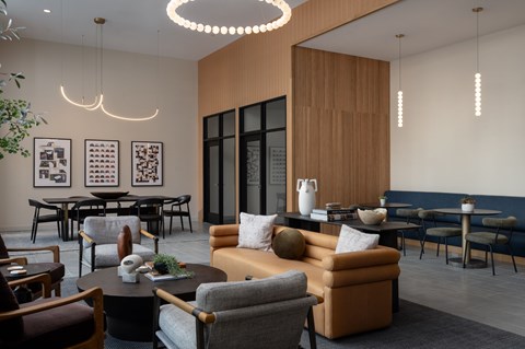 A modern living room with a variety of seating options and a large window.