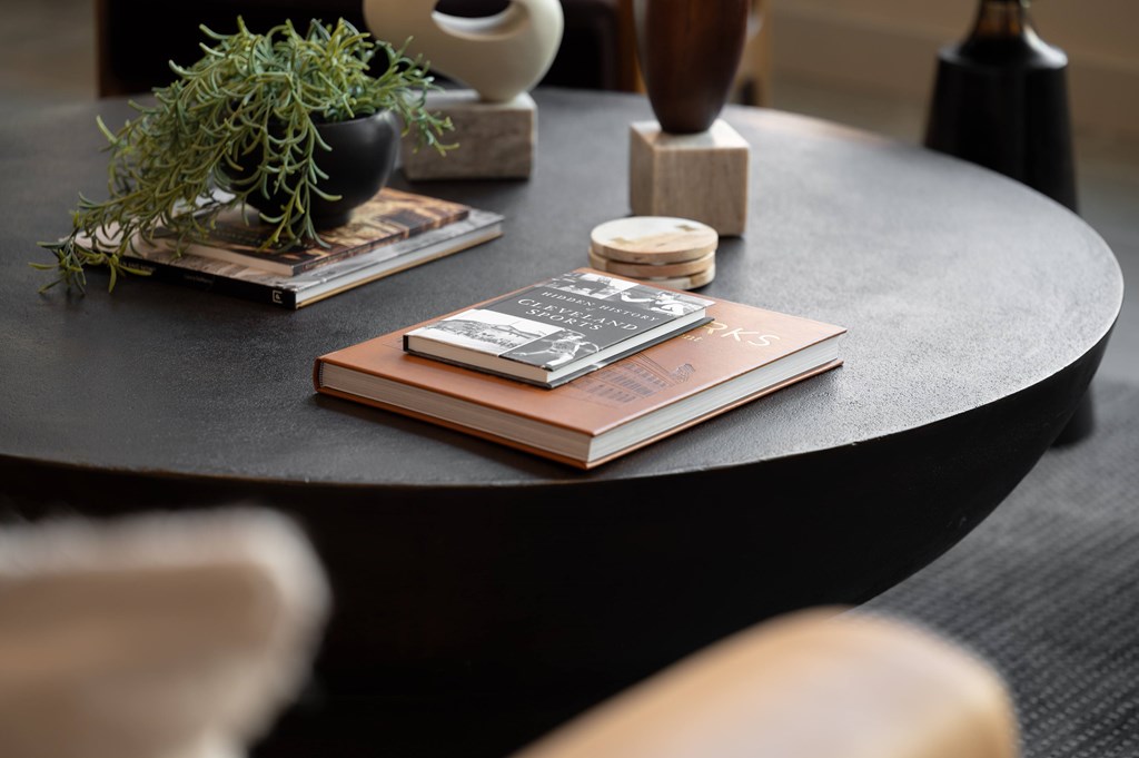 A book with a wooden cover is placed on a round table.