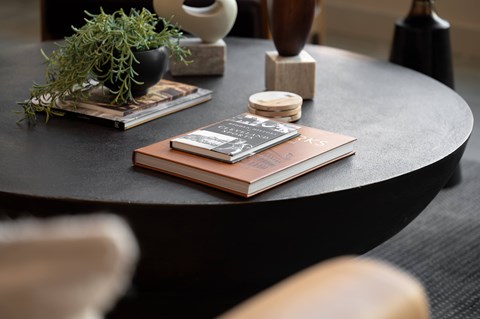 A book with a wooden cover is placed on a round table.