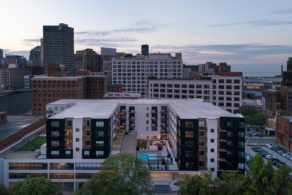 A cityscape with a large building in the foreground and smaller buildings in the background.