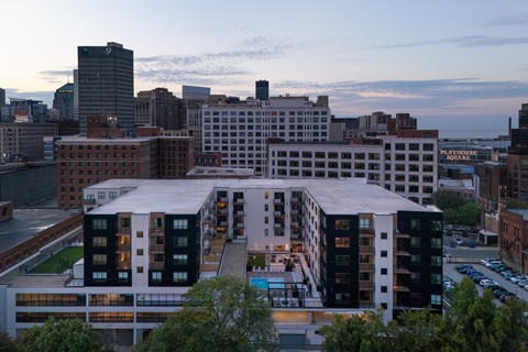 A cityscape with a large building in the foreground and smaller buildings in the background.