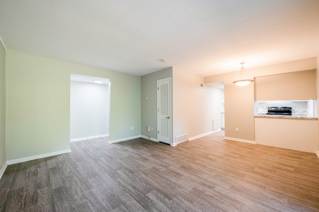 A room with a wooden floor and a window.