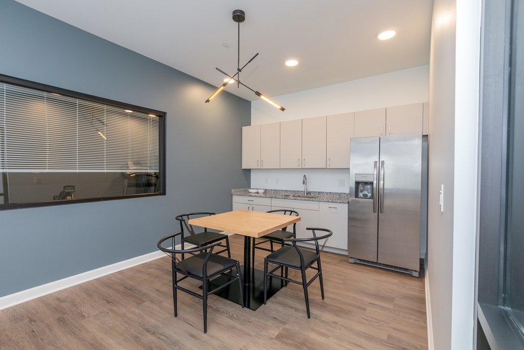 A kitchen with a table and chairs. at The Lumos Apartments, Cleveland 44106