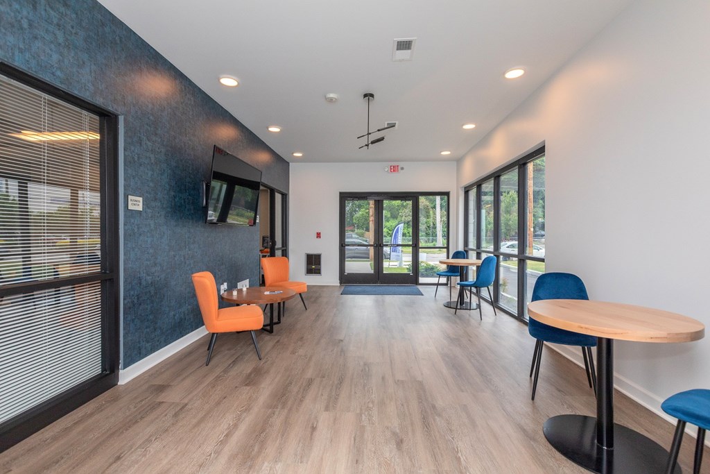 A room with a wooden floor and a white wall with a black door. at The Lumos Apartments, Ohio
