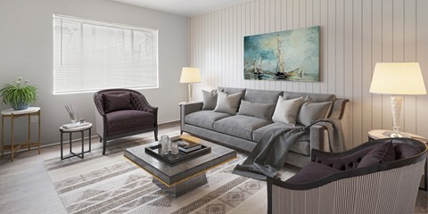 A living room with a grey couch, a chair, and a coffee table.