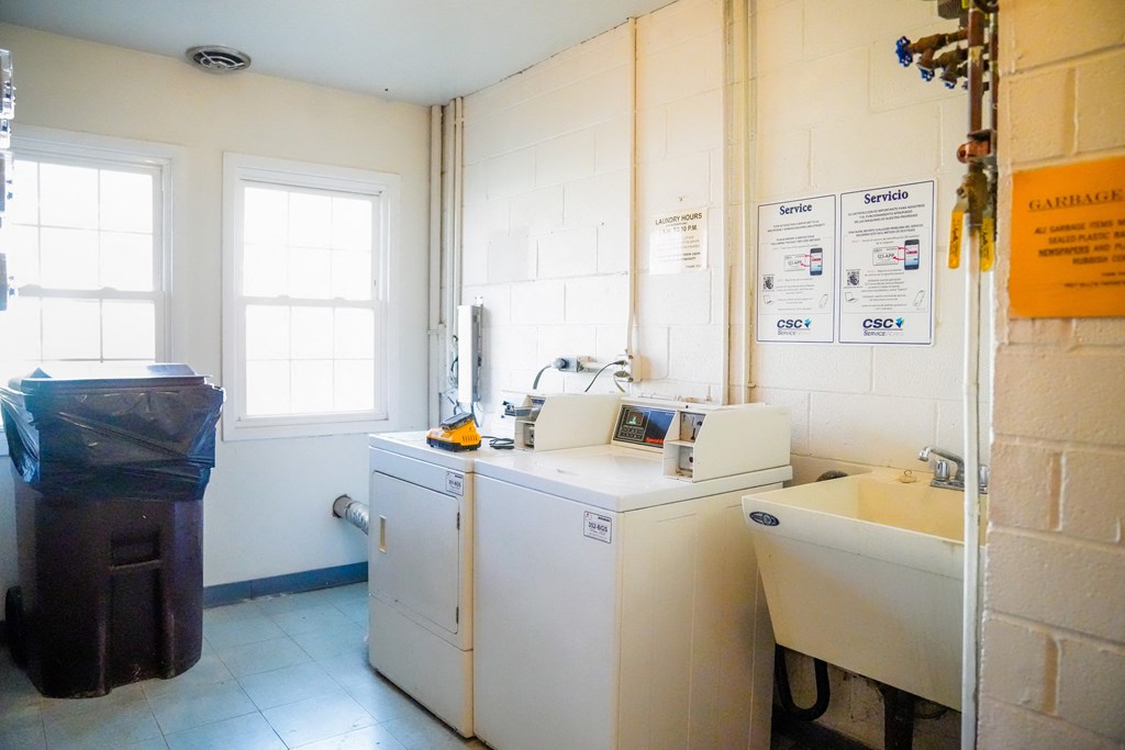 a kitchen with a washing machine and a sink