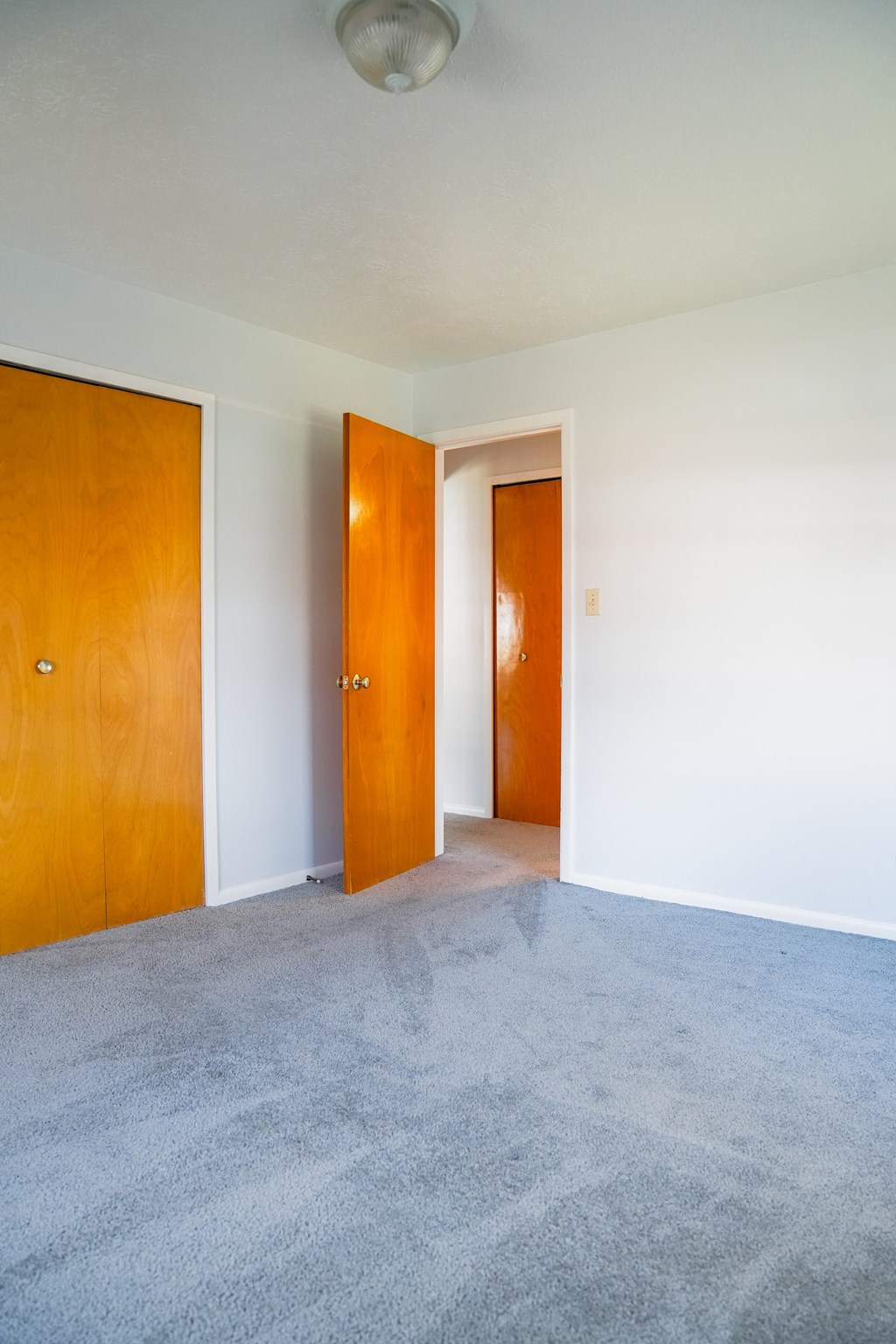 an empty room with two doors in it