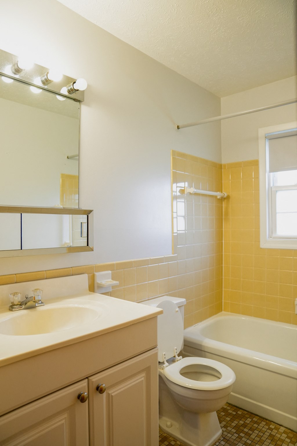 a bathroom with a toilet and a sink and a bath tub