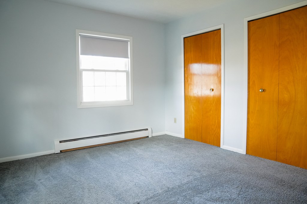 an empty room with a door and a window