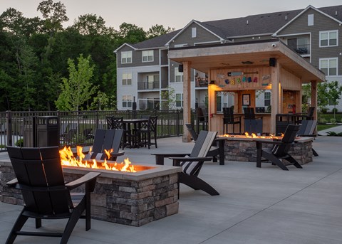 an outdoor entertaining area with a fire pit and patio furniture at The Bend, Lancaster, OH, 43130