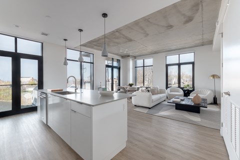 A modern kitchen with white cabinets and a large island.