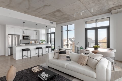 A modern living room with a white sofa and a bar area.