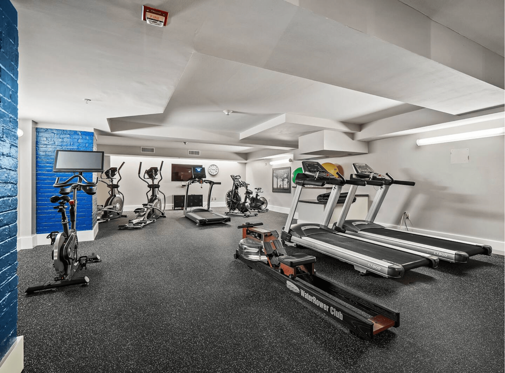 the gym has treadmills and other exercise equipment in the wellness center