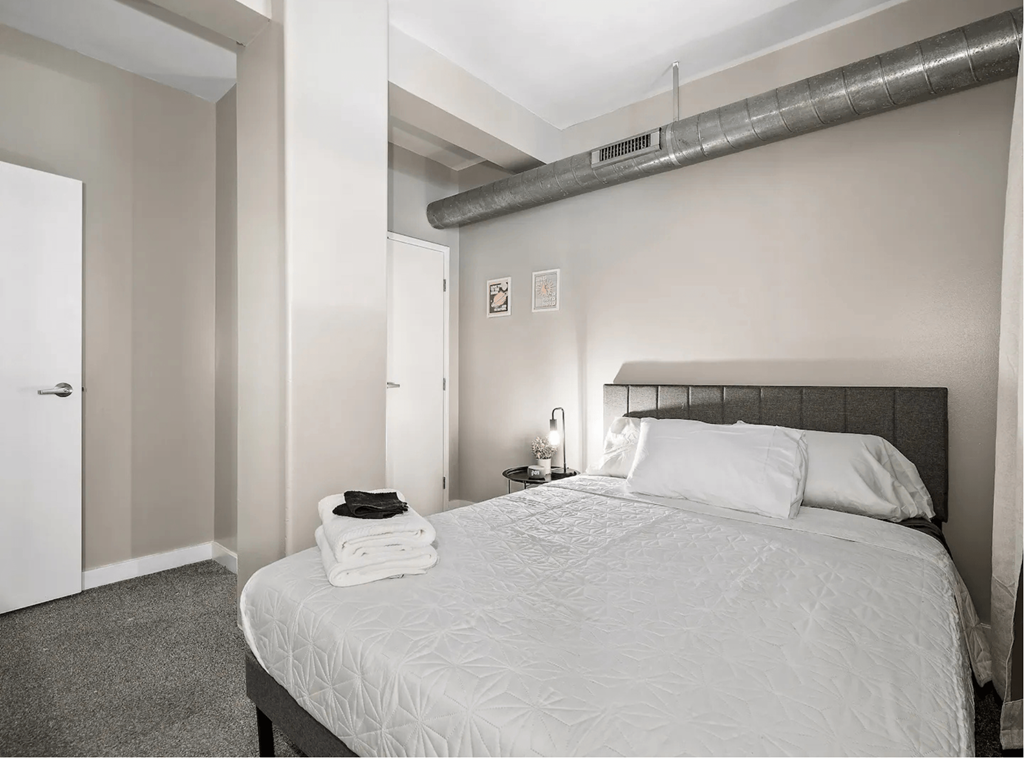 a bedroom with a large bed and a closet