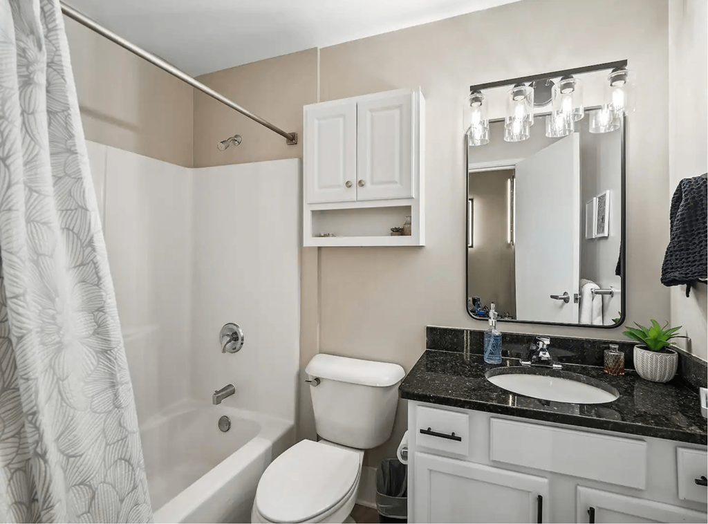 a bathroom with a sink toilet and shower