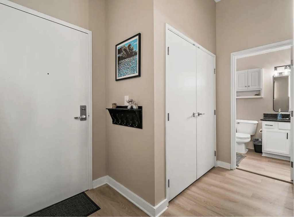 a room with a door to a bathroom and a closet