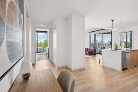 A modern kitchen with a dining table and chairs.