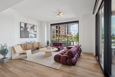 A modern living room with a large window overlooking a cityscape.