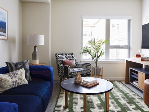 a living room with a blue couch and a coffee table