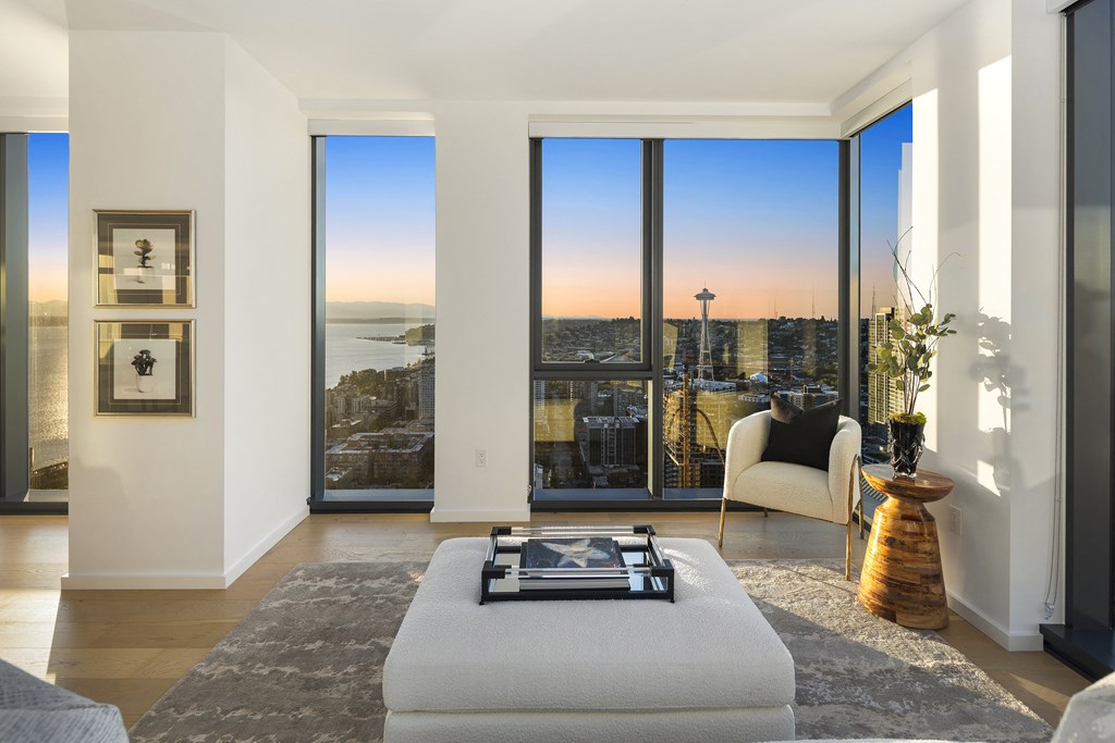 a living room with a large window and a view of the city