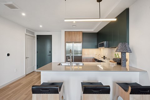 A modern kitchen with a bar stool.
