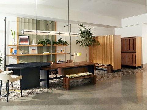 a living room with a table and a desk