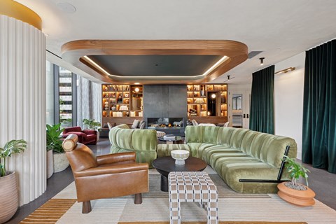 A living room with a green couch and a brown chair.