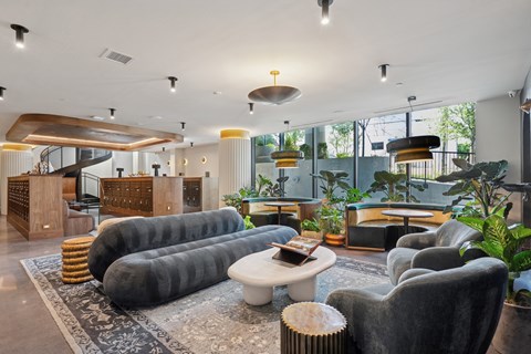 A modern living room with a grey sofa and a wooden coffee table.