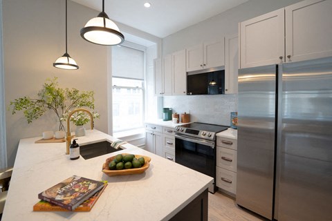 a kitchen with stainless steel appliances and a white counter top