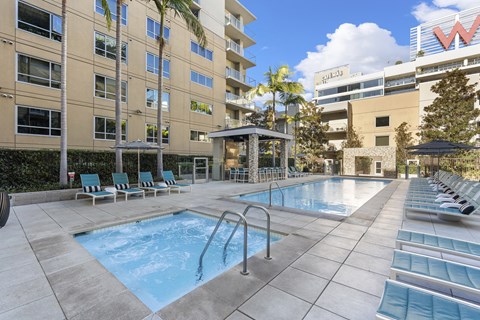 A large outdoor pool with a cabanas and chaise lounges at 1600 Vine, Hollywood.