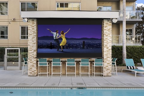 Movie playing on a large movie screen at the pool at 1600 Vine Hollywood CA