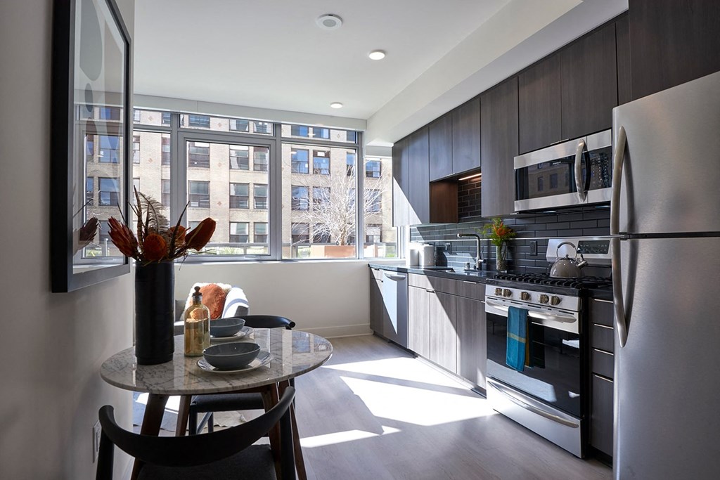 a kitchen with stainless steel appliances and a large window
