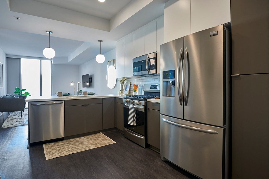 a kitchen with stainless steel appliances and white cabinets