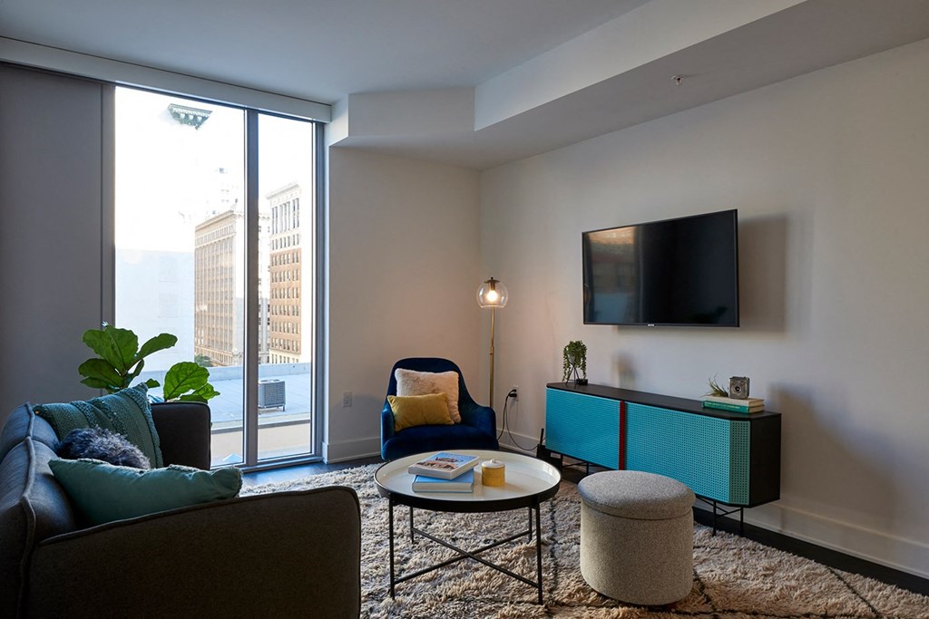 a living room with a couch and a table and a television