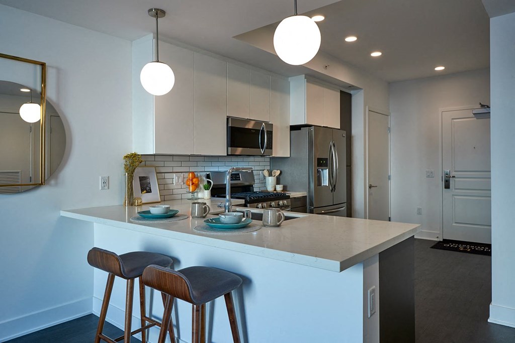 a kitchen with an island and three stools