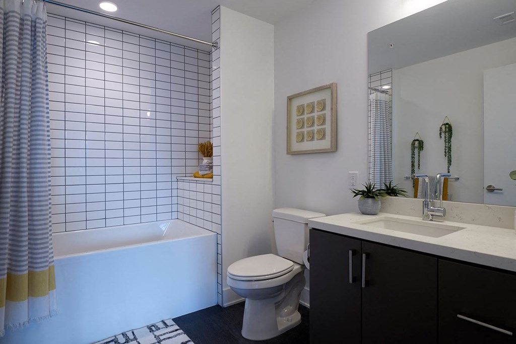 a bathroom with a toilet and a tub and a sink
