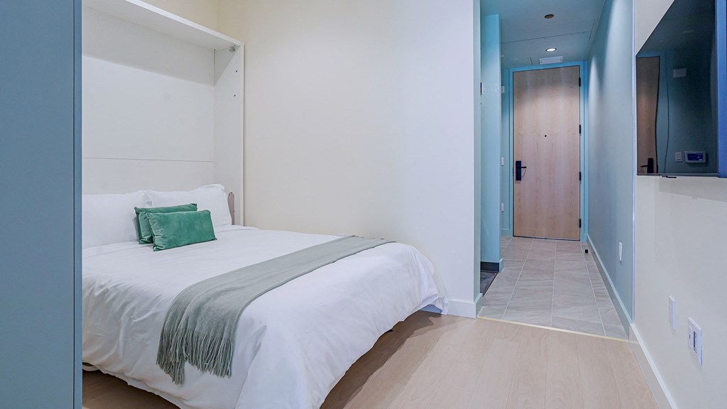 bedroom with smart tv Sentral Beverly Hills apartments