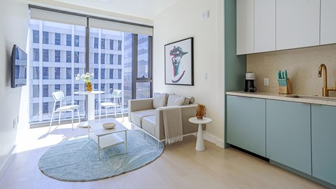 a living room with a couch and a table and a large window
