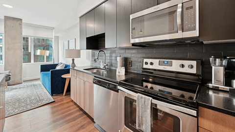A modern kitchen with a stainless steel oven and microwave.