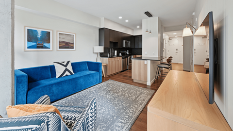 A blue sofa with a white star design on it is in the middle of a room.