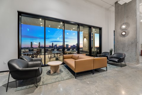A modern living room with a large window overlooking a cityscape.