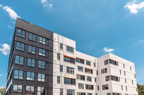 A modern building with a combination of black and white exterior.