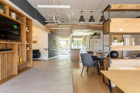 A modern office space with wooden furniture and a long table.