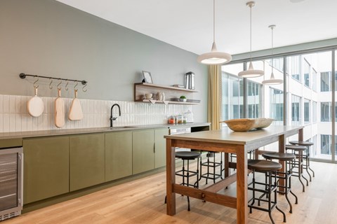a kitchen with a wooden table and a large window