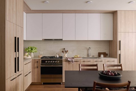 A modern kitchen with wooden cabinets and a black table.