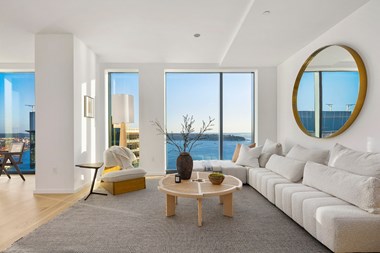 the modern living room with floor to ceiling ocean views