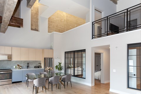 A modern kitchen with a dining table and chairs.