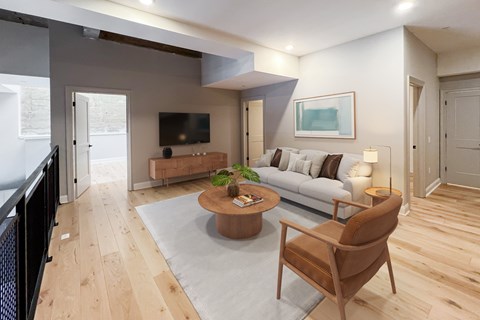 A living room with a brown chair and a grey sofa.